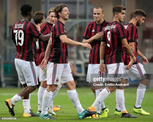 Riccardo Montolivo of AC Milan celebrates his second goal with his team-mates during the UEFA Europa League Qualifying Play-Offs round first leg...