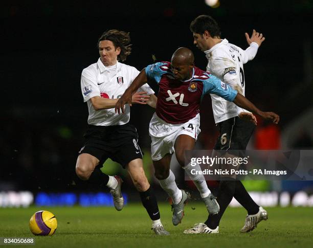 West Ham United's Luis Boa Morte battles for the ball with Fulham's Alexey Smertin and Dejan Stefanovic.