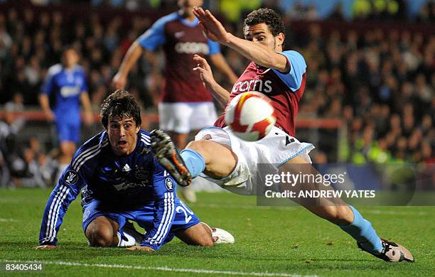 Aston Villa's Spanish defender Carlos Cuéllar clears the ball from Ajax Argentine forward Dario Cvitanich during their UEFA Cup group F football...