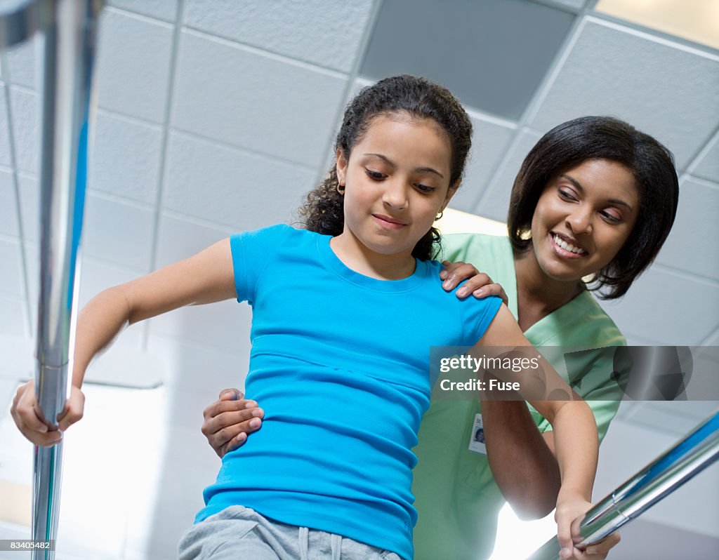 Physical Therapist Assisting Girl