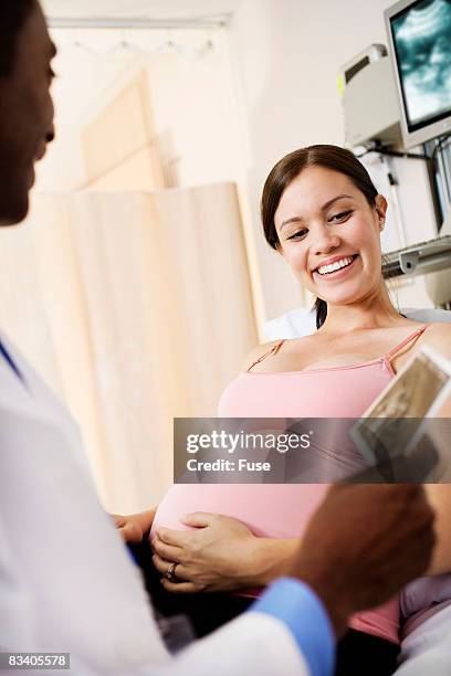 pregnant woman getting ultrasound image of baby - ultra sonography stock pictures, royalty-free photos & images