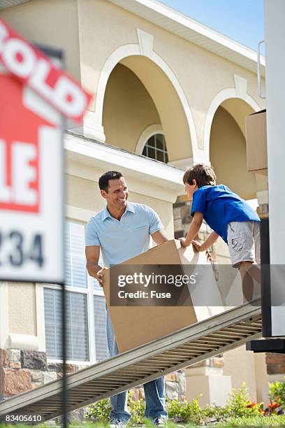 father and son moving into new house - fuse box stock-fotos und bilder