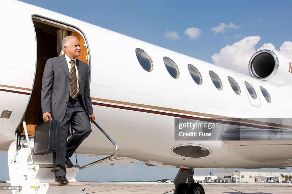 Businessman Disembarking from Plane