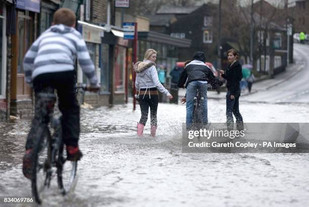 Children play in the floods in Mytholmroyd near Halifax.