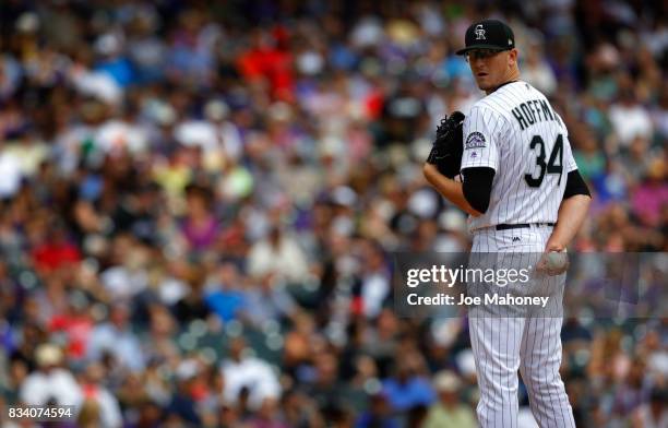 Starting pitcher Jeff Hoffman of the Colorado Rockies looks toward first base in the fourth inning at Coors Field on August 17, 2017 in Denver,...