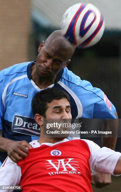 Wycombe Wanderers' Leon Johnson beats Chesterfield's Jack Lester in the air during the League Two match at Adams Park, High Wycombe.