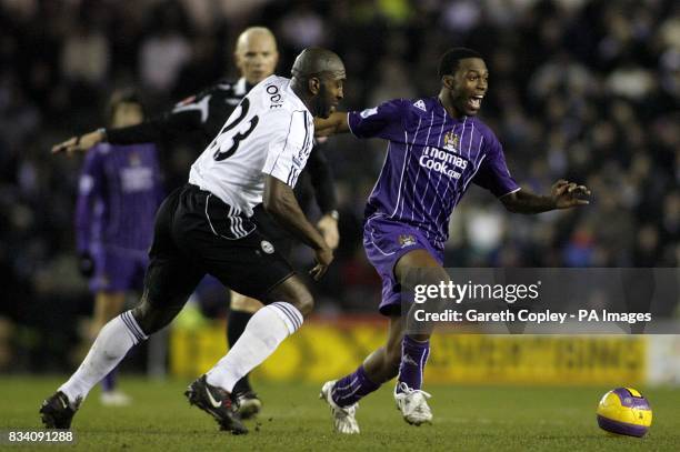 Manchester City's Daniel Sturridge and Derby County's Darren Moore battle for the ball.