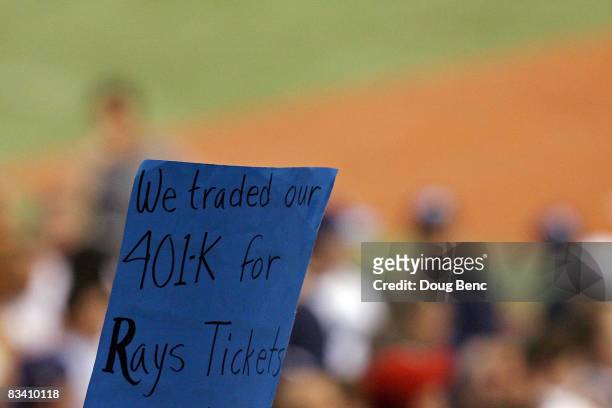 Fan of the Tampa Bay Rays holds up a sign which reads "We traded our 401k for Rays Tickets" against the Philadelphia Phillies during game two of the...