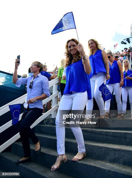 Florentyna Parker of Team Europe waves a flag as she makes her way to the stage during opening ceremony for the Solheim Cup at the Des Moines Golf...