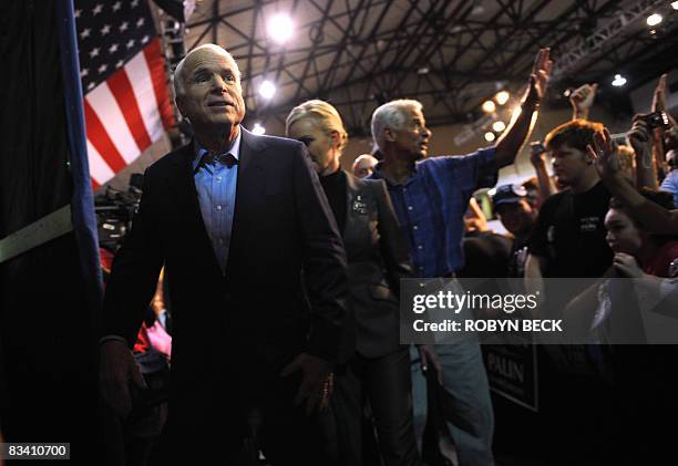 Republican presidential candidate John McCain, his wife Cindy and Florida Governor Charlie Crist wave goodbye to supporters at the end of a campaign...