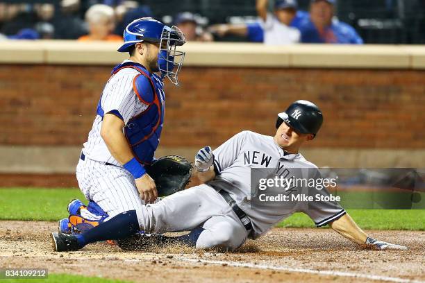 Brett Gardner of the New York Yankees scores on Gary Sanchez RBI single in the fourth inning in front of Travis d'Arnaud of the New York Mets at Citi...