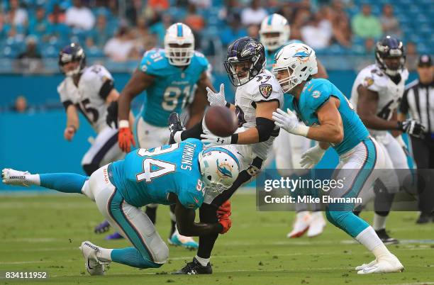 Danny Woodhead of the Baltimore Ravens loses the ball during a preseason game against the Miami Dolphins at Hard Rock Stadium on August 17, 2017 in...