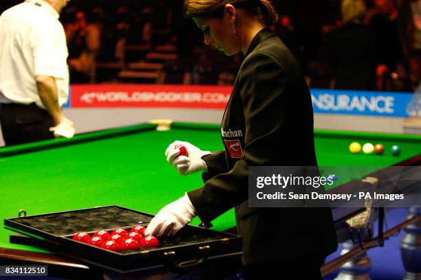 Referee Michaela Tabb cleans the red balls prior to the start of the match