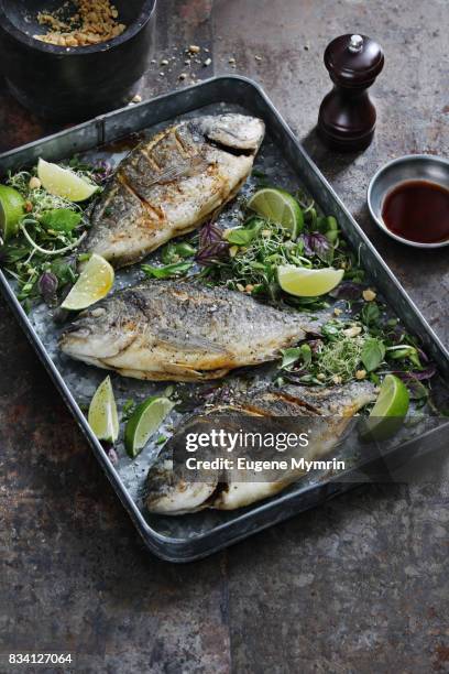 crispy sea breams with herbs and lime - dolphin fish stock pictures, royalty-free photos & images