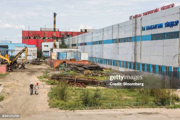 Workers walk through the Darkhan Metallurgical Plant in Darkhan, Mongolia, on Monday, Aug. 14, 2017. Mongolia, desperate to make more of its abundant...