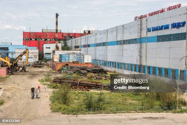 Workers walk through the Darkhan Metallurgical Plant in Darkhan, Mongolia, on Monday, Aug. 14, 2017. Mongolia, desperate to make more of its abundant...