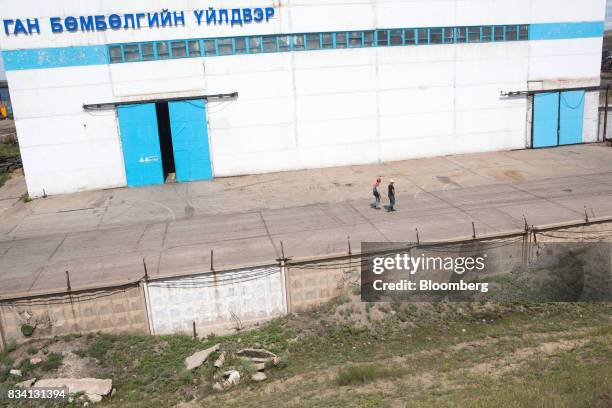 Workers walk through the Darkhan Metallurgical Plant in Darkhan, Mongolia, on Monday, Aug. 14, 2017. Mongolia, desperate to make more of its abundant...