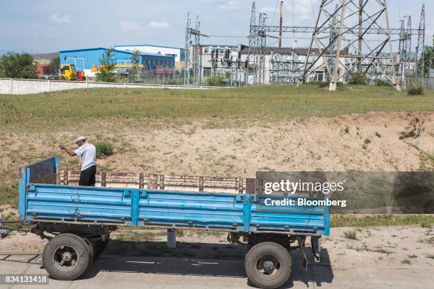 Man repairs a truck trailer outside the Darkhan Metallurgical Plant in Darkhan, Mongolia, on Monday, Aug. 14, 2017. Mongolia, desperate to make more...