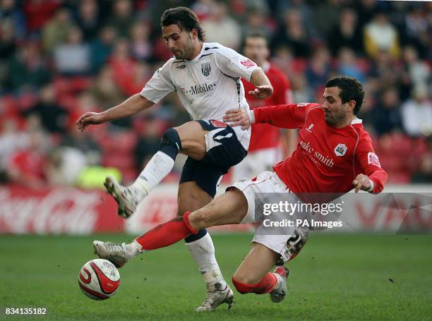 West Bromwich Albion's Andrade Filipe Teixeira battles with Barnsley's Martin Devaney during the Coca-Cola Championship match at Oakwell, Barnsley.