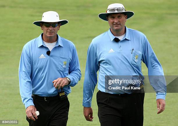Umpires Paul Reiffel and Paul Wilson head from the field during the Ford Ranger Cup match between the Western Australian Warriors and the New...