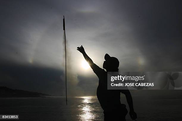 Fisherman fires a firework during a procession to Saint Raphael Archangel at the port of La Libertad, 35 km south of San Salvador, on October 23,...