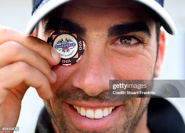 Alvaro Quiros of Spain poses with his lucky poker chip that he uses as a ball marker after the second round of the Castello Masters Costa Azahar at...