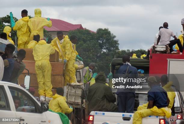 The coffins of victims of a mudslide are carried to the cemetery on trucks draped with the Sierra Leone flag in Freetown, Sierra Leone on August 17,...