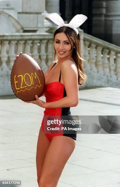 Page Three girl Kathy Lloyd poses in London's Trafalgar Square this morning with as giant chocolate easter egg advertising this week's 20 million...