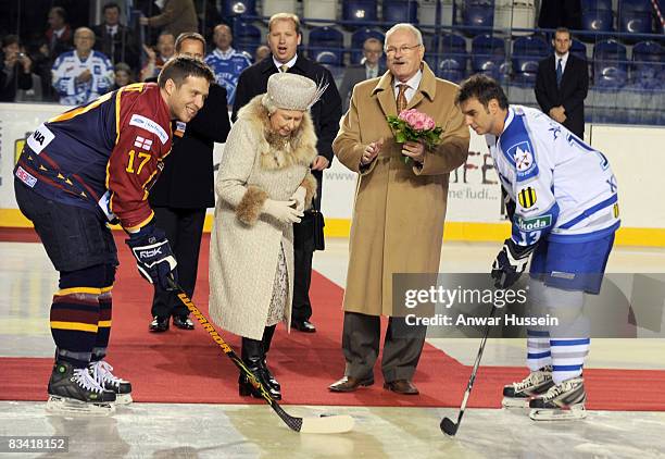 Queen Elizabeth ll, accompanied by President Ivan Gasparovic, throws in the puck to start an ice hockey match between Aqua City Poprad and Guildford...