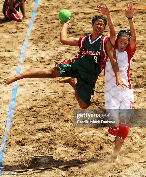 Ari Wahyuni Ni Made of Indonesia shoots at goal over Rasha Obeidat of Jordan in the Womens Beach Handball on day seven of the 2008 Asian Beach Games...
