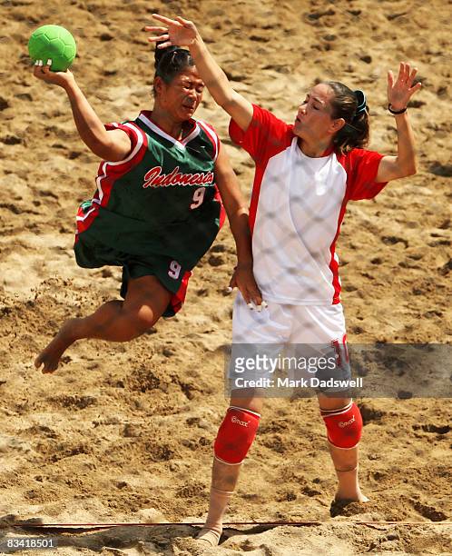 Ari Wahyuni Ni Made of Indonesia shoots at goal over Rasha Obeidat of Jordan in the Womens Beach Handball on day seven of the 2008 Asian Beach Games...