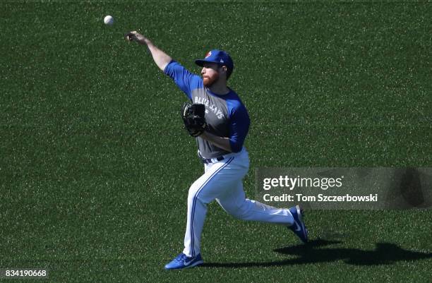 Danny Barnes of the Toronto Blue Jays warms up in the outfield during batting practice before the start of their MLB game against the Tampa Bay Rays...