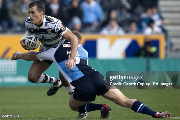 Harlequins' Scott Hill tackles Hull FC's Todd Byrne