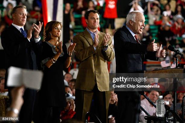 Denver Broncos former quarterback John Elway and his fiancee Paige Green and former Broncos player John Lynch listen to Republican presidential...