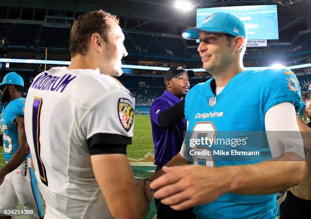 Jay Cutler of the Miami Dolphins and Josh Woodrum of the Baltimore Ravens shake hands following a preseason game at Hard Rock Stadium on August 17,...