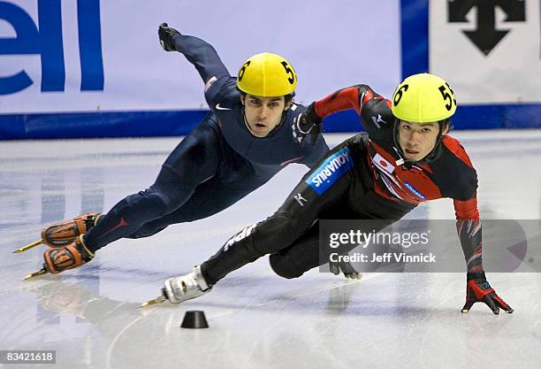 Takahiro Fujimoto of Japan and Anthony Lobello of the United States lean into a corner during their 1000m heat at the ISU World Cup Speed short track...