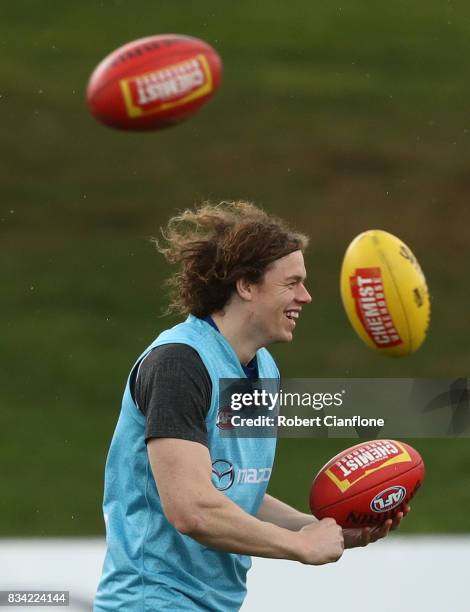 Ben Brown of the Kangaroos handballs during a North Melbourne Kangaroos AFL training session at Arden Street Ground on August 18, 2017 in Melbourne,...