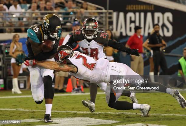 Allen Robinson of the Jacksonville Jaguars attempts a reception against Chris Conte of the Tampa Bay Buccaneers during a preseason game at EverBank...