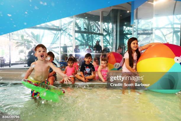 Children play in a 11 metre long swimming pool to celebrate the Australian premiere of The Pool exhibition at the National Gallery of Victoria...