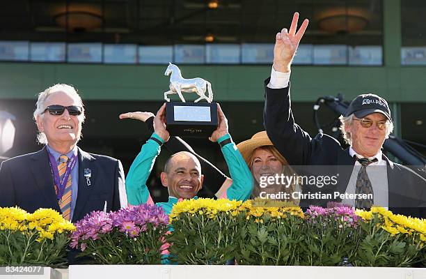 Owner Jerome Moss, jockey Mike Smith and trainer John Shirreffs celebrate their win after Zenyatta finished first in the Breeders' Cup Ladies Classic...