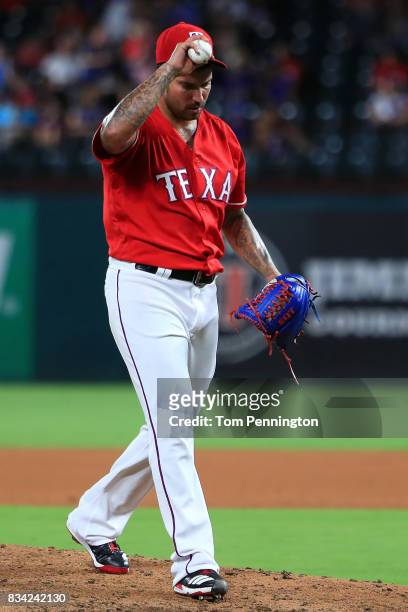 Matt Bush of the Texas Rangers reacts after giving up a run against the Chicago White Sox in the top of the seventh inning at Globe Life Park in...
