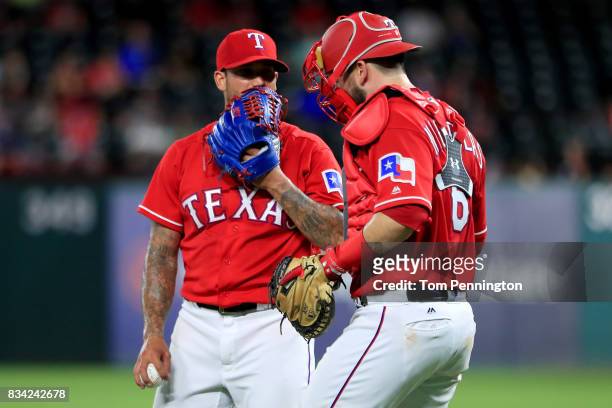 Matt Bush of the Texas Rangers talks with Brett Nicholas of the Texas Rangers after giving up a run against the Chicago White Sox in the top of the...