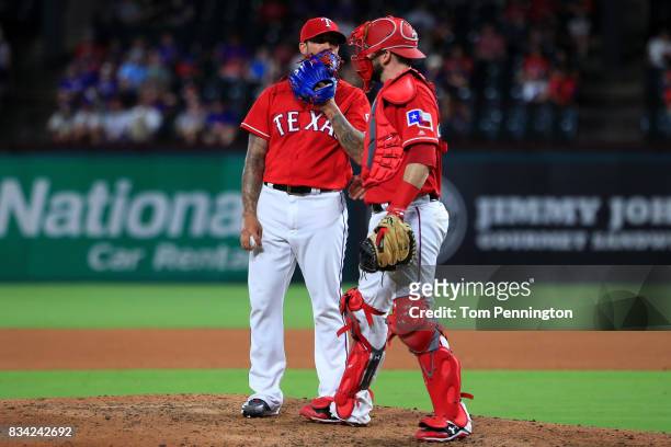 Matt Bush of the Texas Rangers talks with Brett Nicholas of the Texas Rangers after giving up a run against the Chicago White Sox in the top of the...