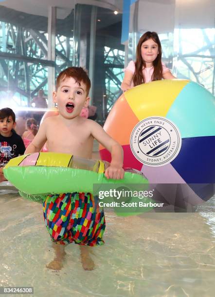 Children play in a 11 metre long swimming pool to celebrate the Australian premiere of The Pool exhibition at the National Gallery of Victoria...