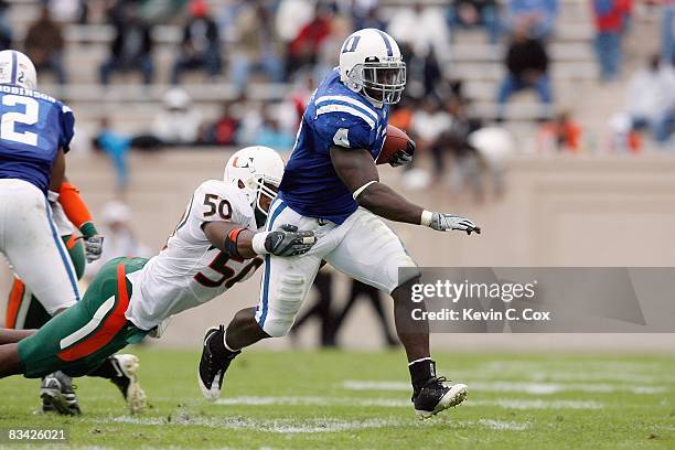 Clifford Harris of the Duke Blue Devils carries the ball against Darryl Sharpton of the Miami Hurricanes at Wallace Wade Stadium on October 18, 2008...