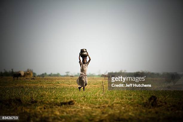 Woman goes to fill up a water bucket in the polluted and diminishing water of central Africa's Lake Chad on July 10, 2007 around Lake Chad, Chad.