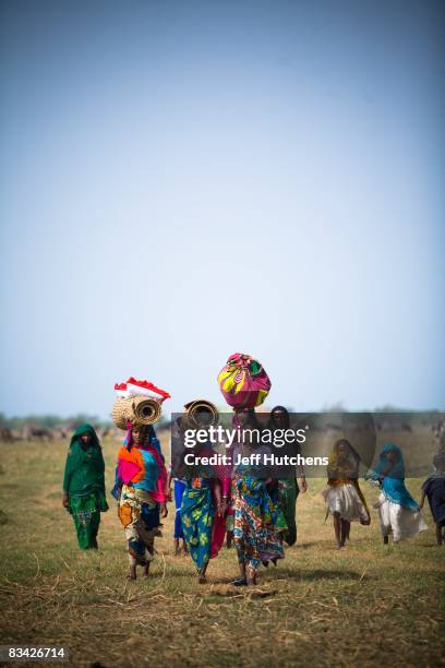 Mothers and children walk outside their nomadic village on the shores of polluted and rapidly diminishing Lake Chad on July 10, 2007 around Lake...