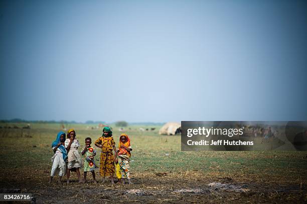 Children stand outside their nomadic village on the shores of polluted and rapidly diminishing Lake Chad on July 10, 2007 around Lake Chad, Chad.