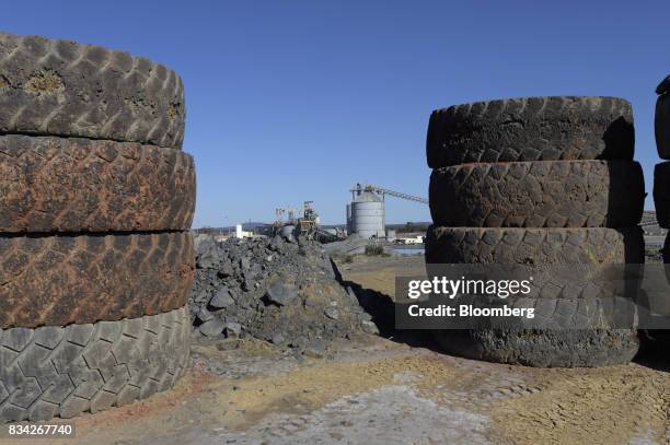 Storage silo is framed by used tires at a landfill area of Evolution Mining Ltd.'s gold operations in Mungari, Australia, on Tuesday, Aug. 8, 2017....