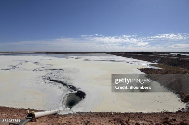 Pipe leads into a tailings dam that is covered with hardened waste at Evolution Mining Ltd.'s gold operations in Mungari, Australia, on Tuesday, Aug....